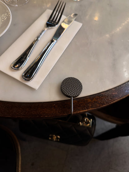 Elegant handbag hook designed to keep your designer bag off the floor at restaurants.